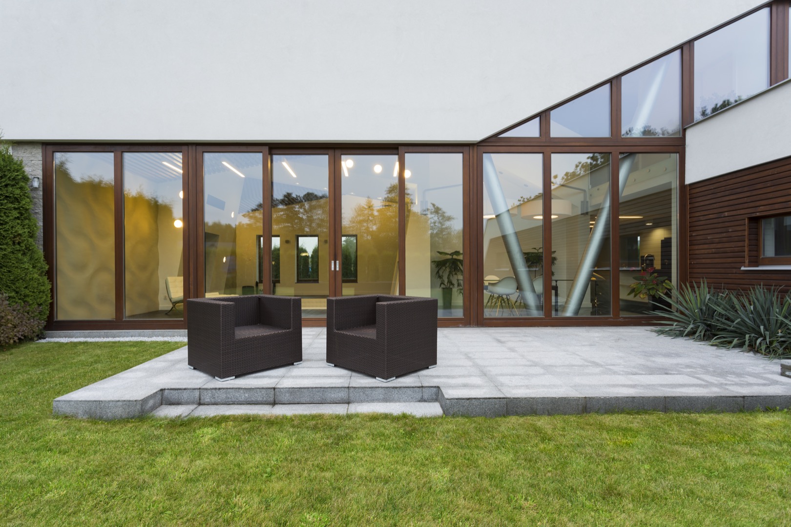 Villa patio with rattan chairs Villa with pool
